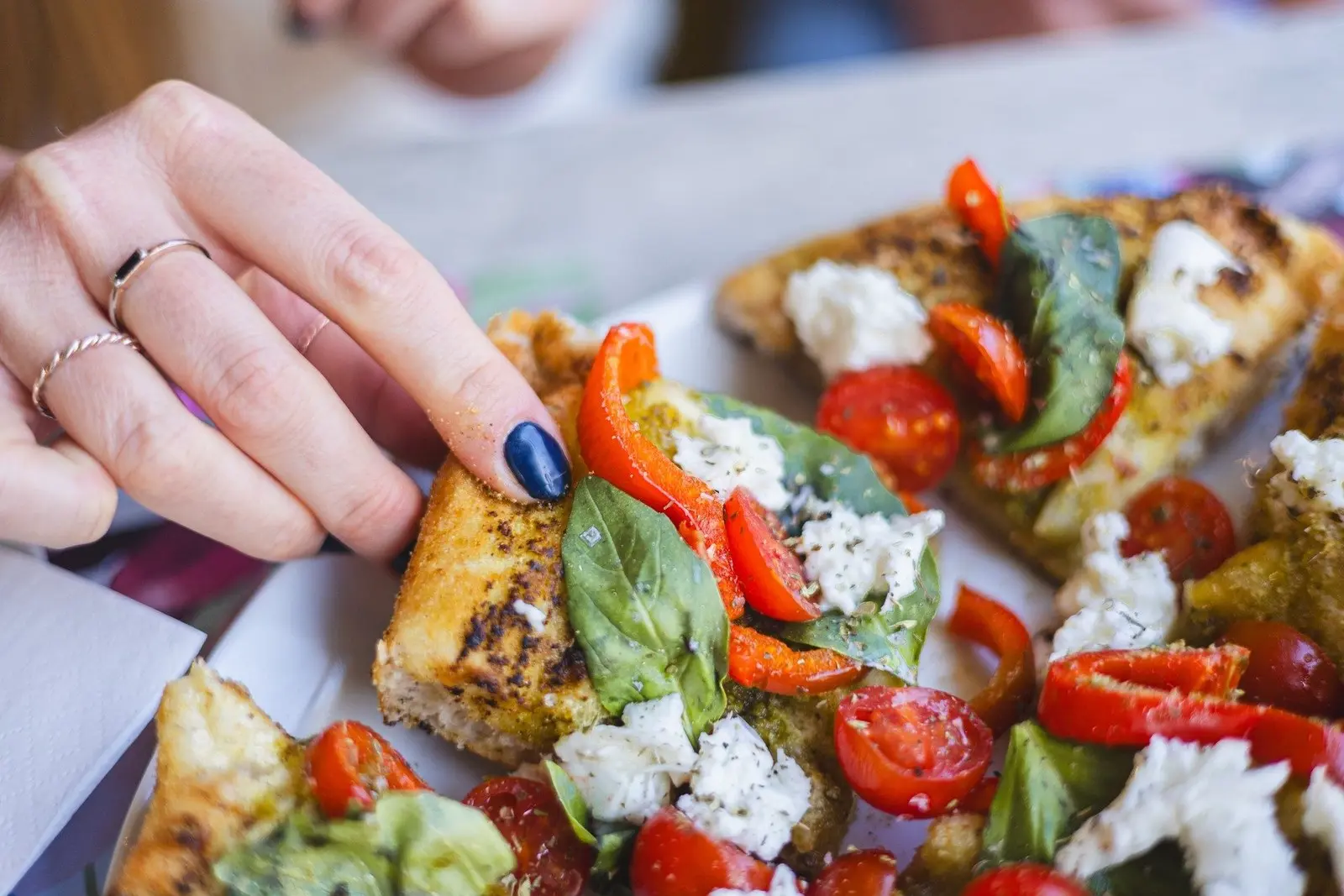 Toasted bread with tomatoes, peppers and soft cheese at ENCANTO
