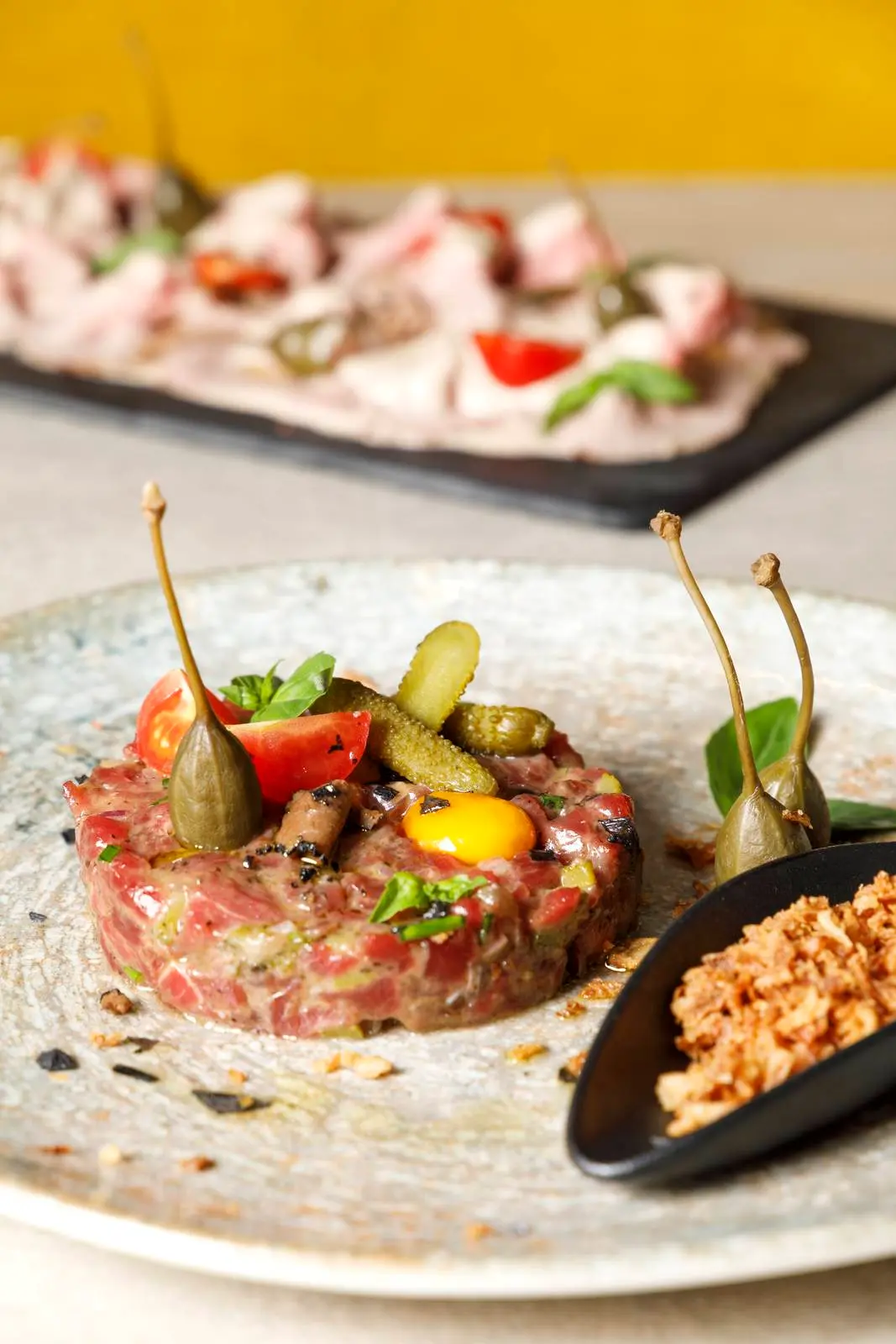 Steak tartare with caper berries at ENCANTO