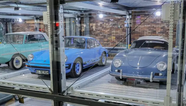 Classic cars in glass display bays at Motorworld Mallorca