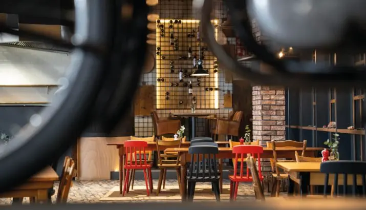 Restaurant tables and colorful chairs at Motorworld Mallorca
